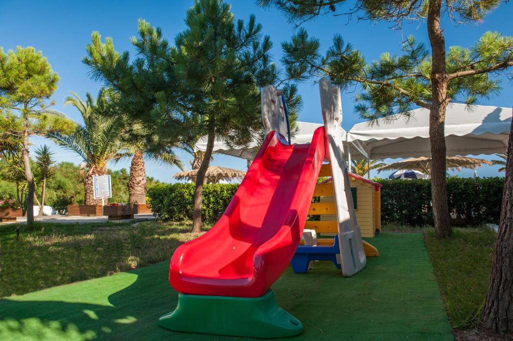 a slide at a resort with a playground at Kalamaki Beach Hotel, Zakynthos Island in Kalamaki
