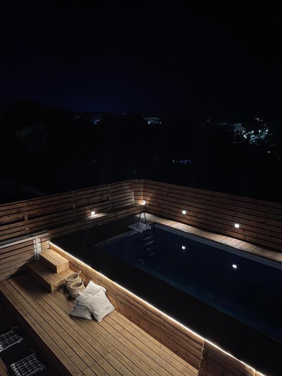 a swimming pool on the roof of a building at night at Casa de Manu in Rhodes Town