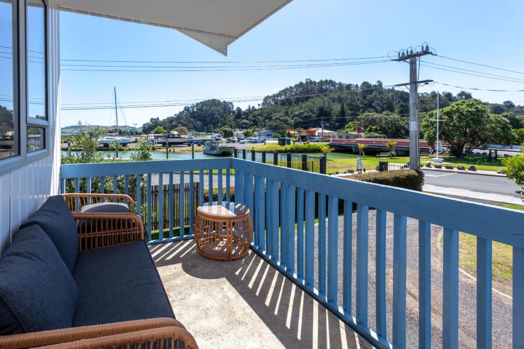 a balcony with a couch and a view of a street at Heart of town in Coromandel Town