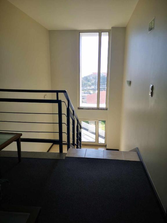 an empty room with a staircase and a window at Hotel Euro Moniz in Porto Moniz