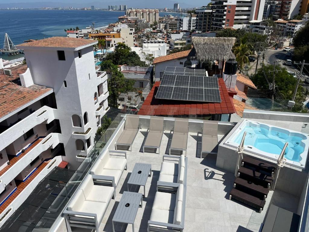 an aerial view of a building with solar panels on the roof at Vidalia - Modern Condos with Rooftop Terrace and Gym in Puerto Vallarta