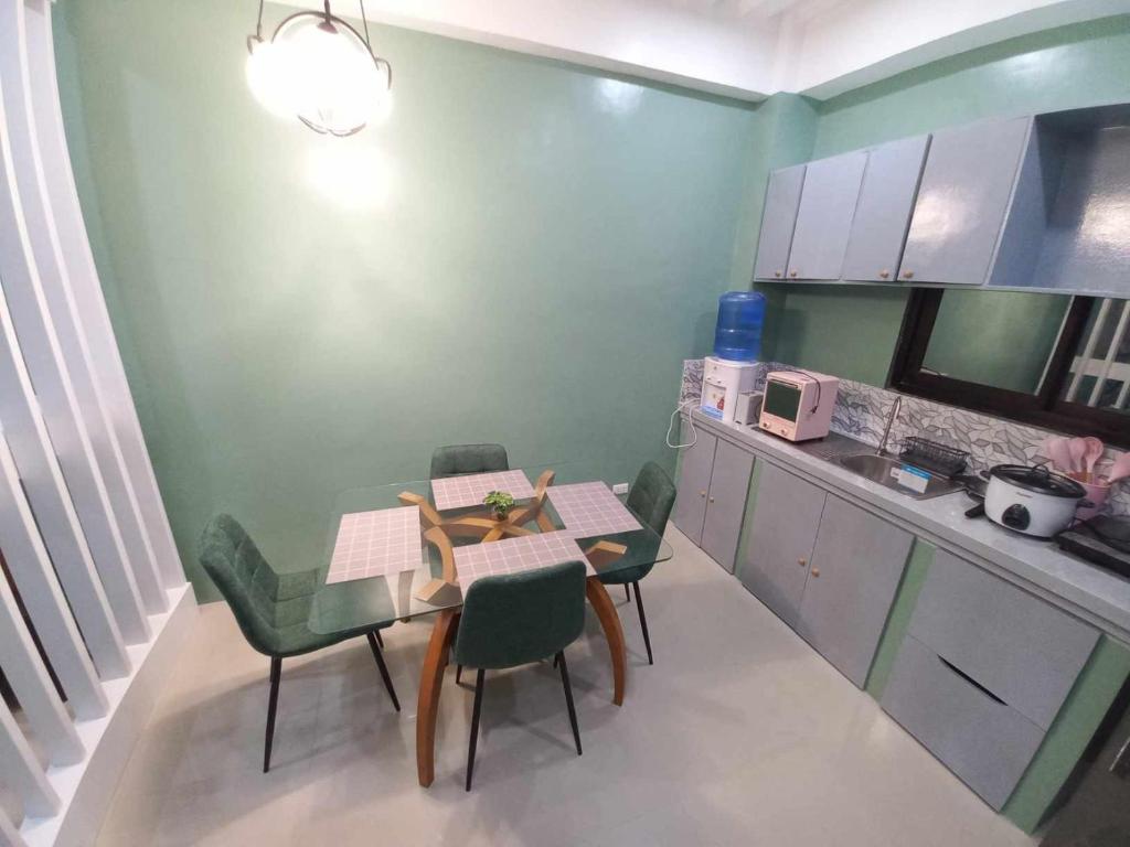 a small kitchen with a table and chairs in a room at ConVill Residences in General Santos