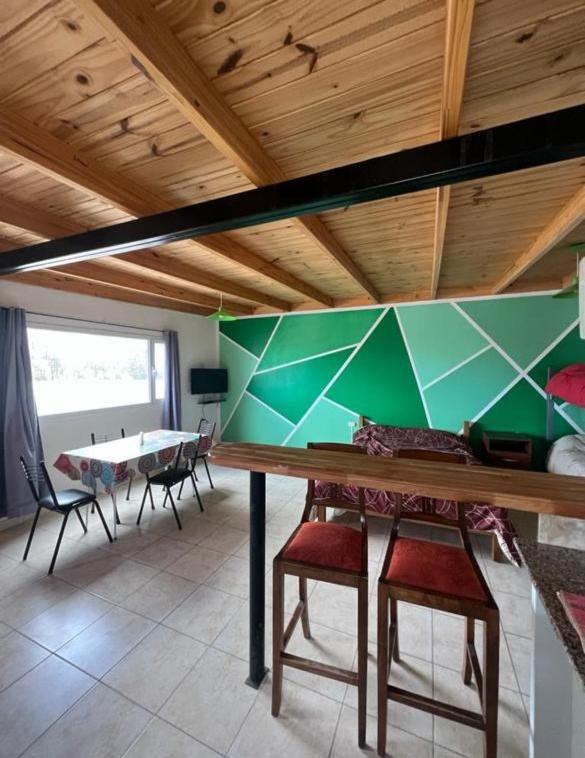 a room with a table and some chairs and a table at Depto Ruta 3 in Trelew