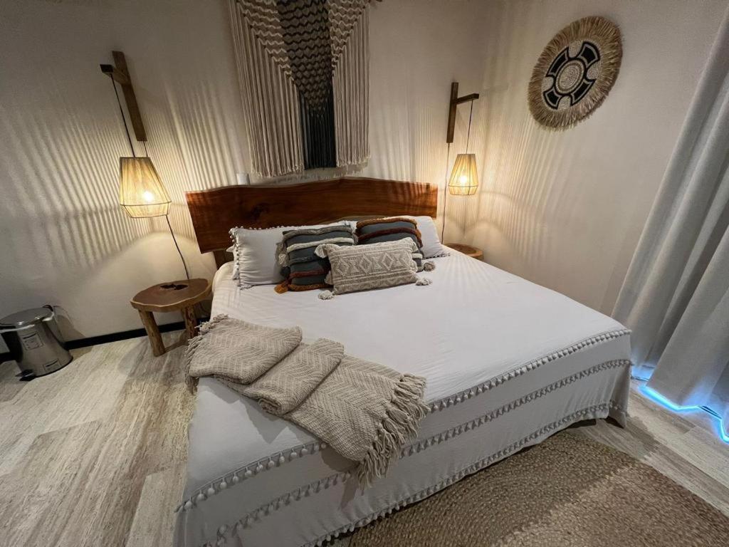 a bedroom with a bed with towels on it at Casa del Sol in Tulum