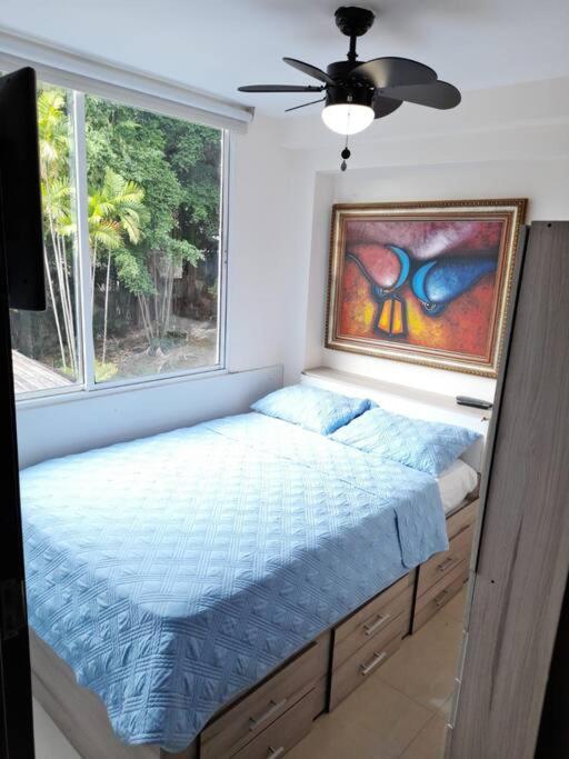 a bedroom with a bed in front of a window at R.5-5 Lindo estudio, 2 recámaras en zona turística in Panama City