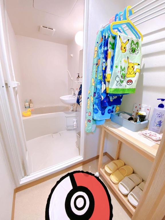 a small childs bathroom with a sink and a shower at Pokémon Sleep 宝可梦的家 in Osaka