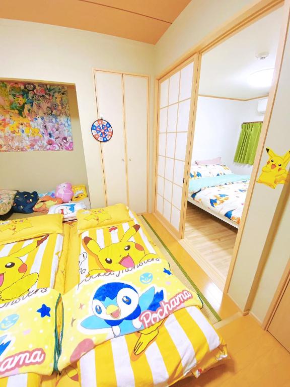 a bedroom with two beds and a mirror at Pokémon Sleep 宝可梦的家 in Osaka