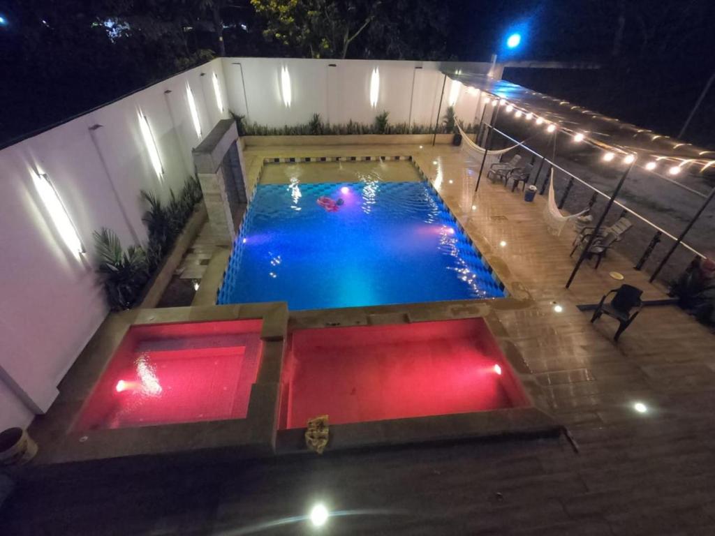 an overhead view of a swimming pool at night at VILLA SARAMI in Villavicencio