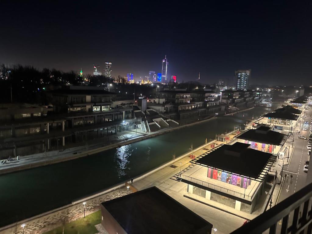 a view of a city at night with a river at Luxury studios in Tashkent