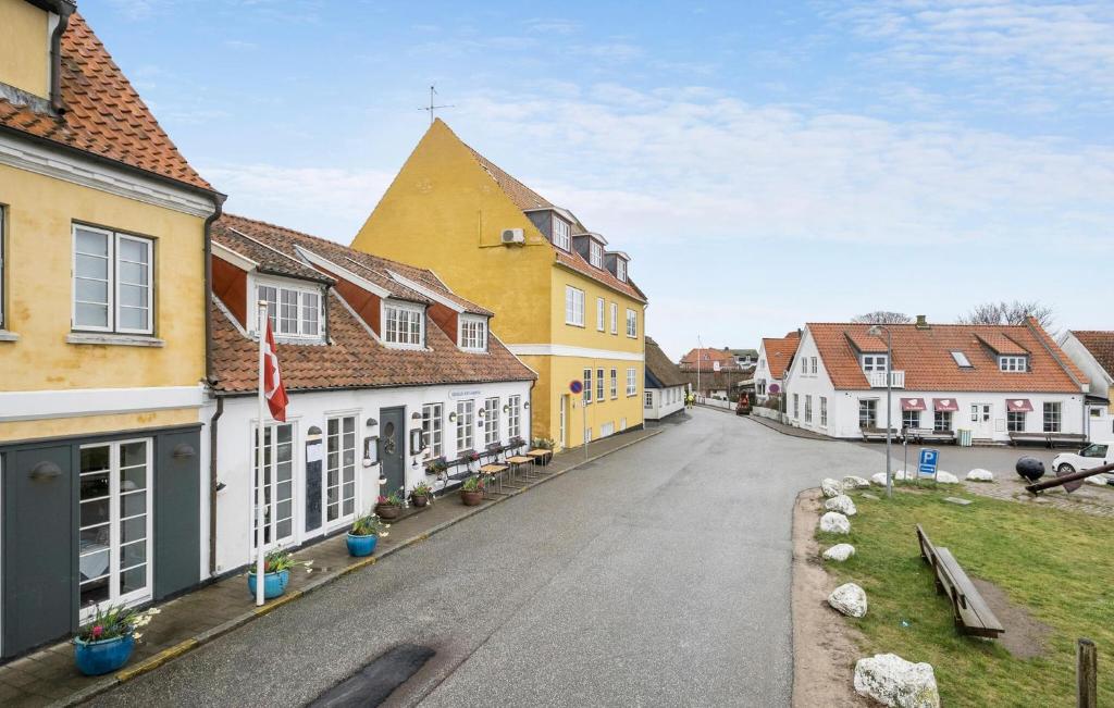 an empty street in a town with yellow and white buildings at 1 Bedroom Cozy Apartment In Gilleleje in Gilleleje