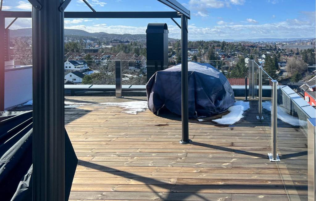 a covered deck with a view of a city at Lovely Home In Oslo With Kitchen in Oslo