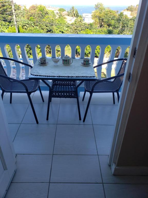 a table and chairs on a balcony with a view at Sk SHaven #2 in Castries