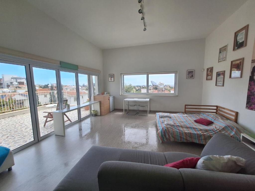 a living room with a couch and a bed at Limassol sea view studio in Limassol