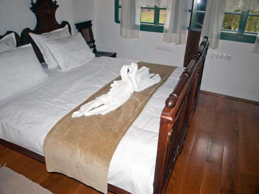 a bed with a white robe on top of it at Ferienwohnung für 2 Personen 1 Kind ca 50 qm in Kratecko, Zentralkroatien Naturpark Lonjsko polje 