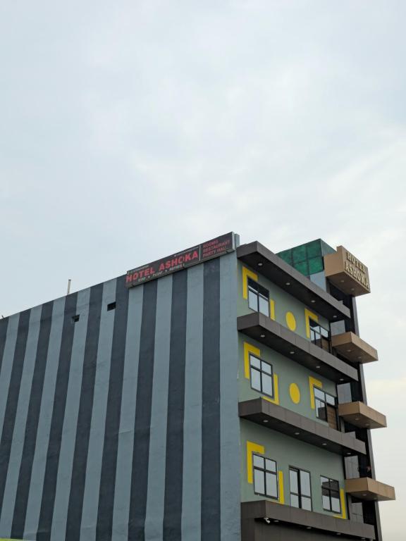 a building with a sign on top of it at Hotel AshokA in Etah