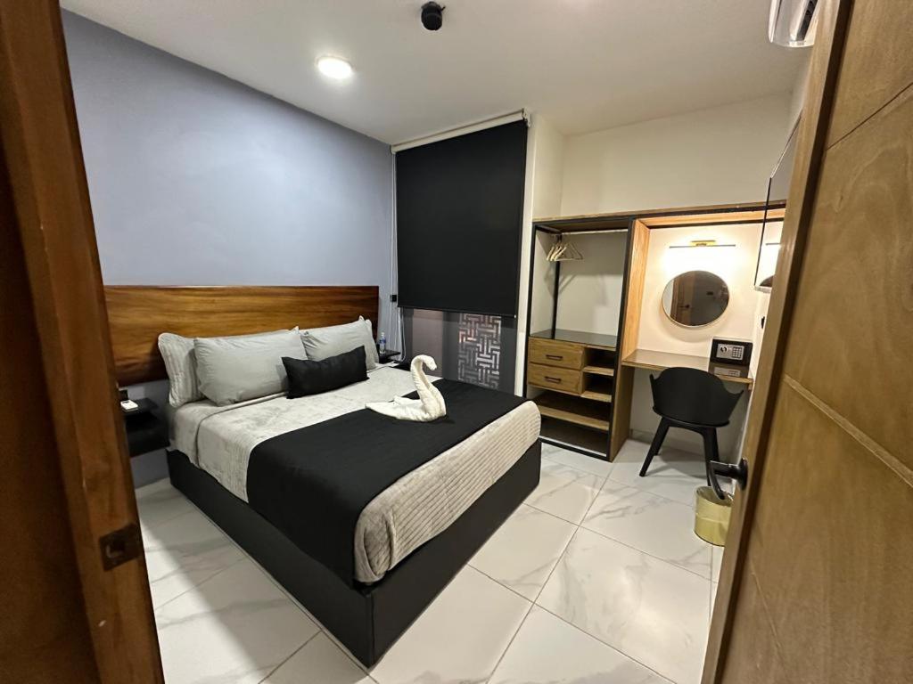 Postel nebo postele na pokoji v ubytování HOTEL PALENQUE PREMIER
