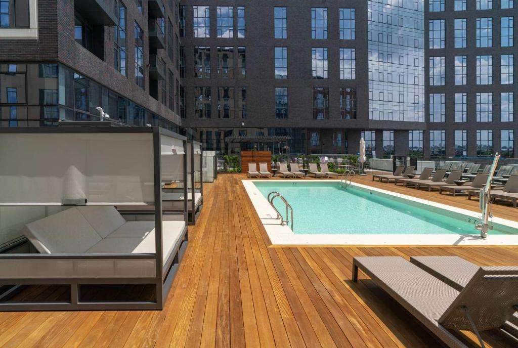 a large swimming pool on a building with chairs at Orchard Group Boston in Cambridge