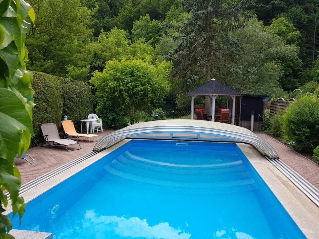 a swimming pool with a gazebo in a yard at on the Werraufer Modern retreat 