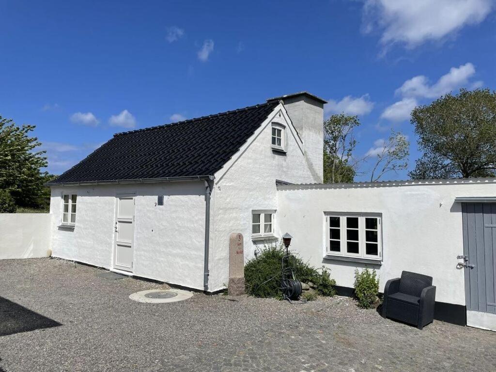a white house with a garage and a driveway at Ocean View Modern Retreat in Neksø
