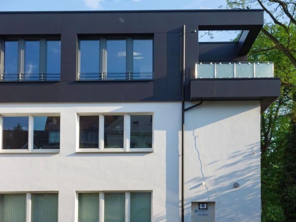 a building with a balcony on the side of it at im Penthouse am Wolfsberg in Lüdinghausen