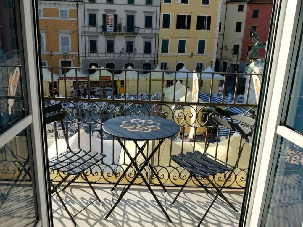 a table and two chairs on a balcony at The Sarzana Suite in Sarzana