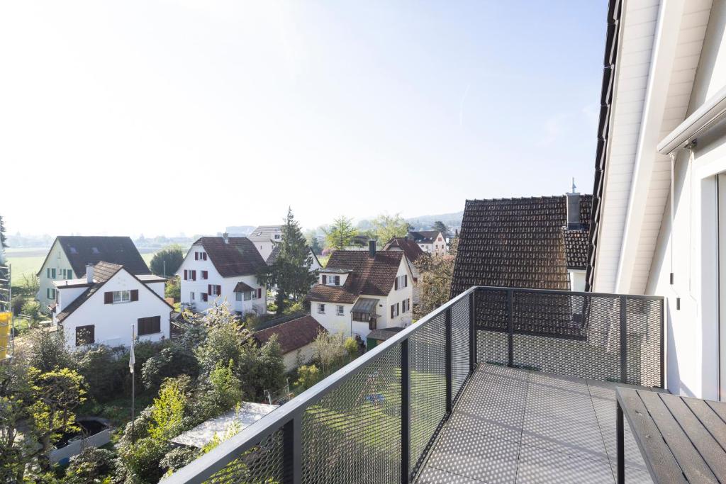 a balcony with a view of a town at STAYY Flagship Limmattal - contactless check-in in Schlieren