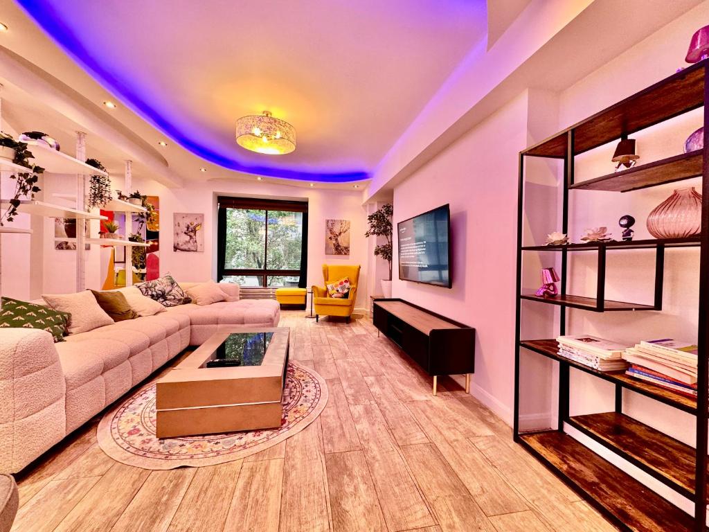 a large living room with a purple ceiling at One Hyde Park by Wild London in London