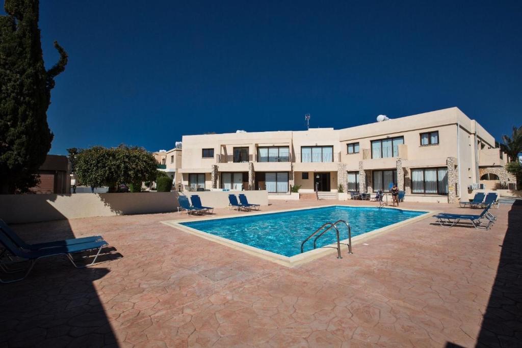 a house with a swimming pool in front of a building at Ferienwohnung für 5 Personen ca 1 qm in Agia Napa, Südküste von Zypern in Ayia Napa