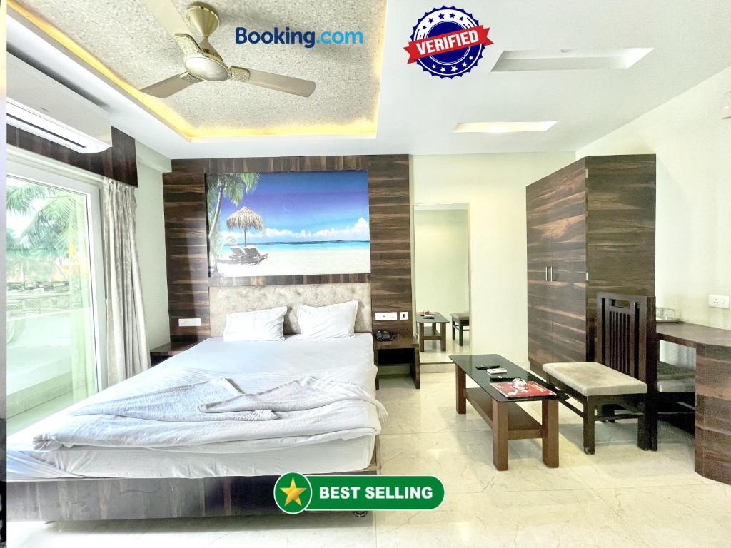 a bedroom with a bed and a desk and a table at Hotel R R . Puri fully-air-conditioned-hotel near-sea-beach-&-temple with-lift-And restaurant-availability in Puri