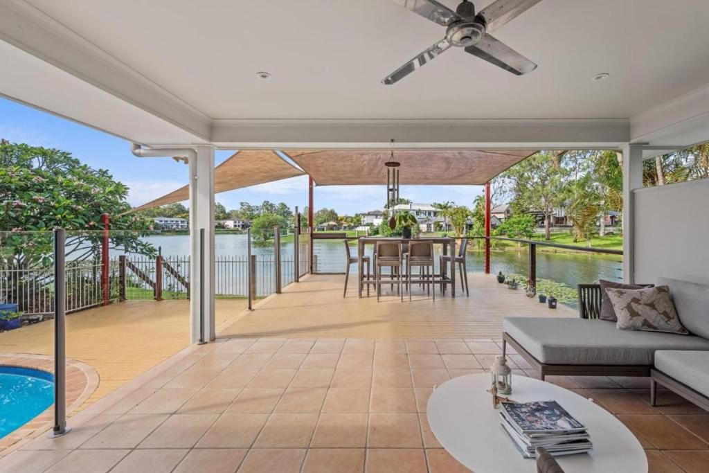 an open patio with a couch and a table at Serene Lakefront Villa with Private Pool 