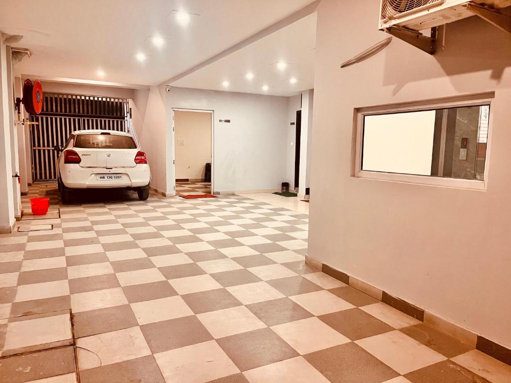 a car parked in a garage with a checkered floor at Sandhya INN in Rishīkesh