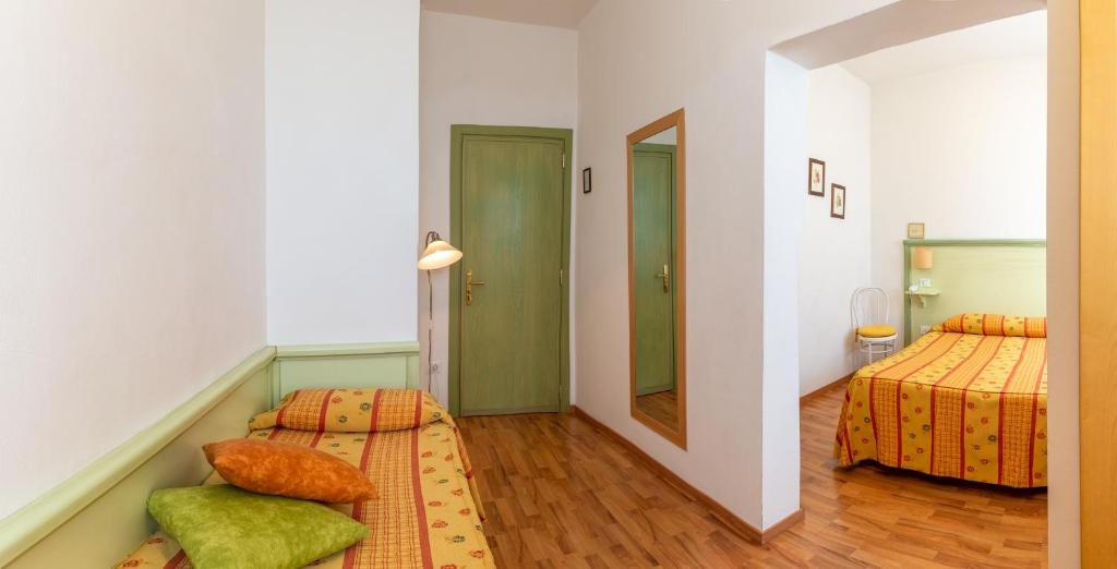 Postel nebo postele na pokoji v ubytování Hotel Minerva