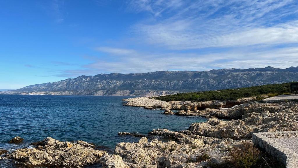 a large body of water with mountains in the background at Fadila in Novalja