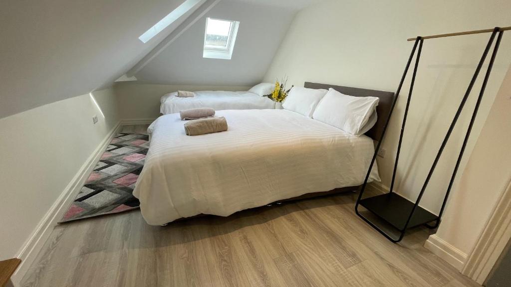 a bedroom with two beds in a attic at Spire attic apartment no kitchen in Dublin