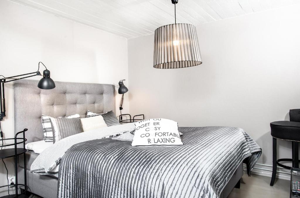 a white bedroom with a bed with a pillow on it at Vivante Basement Accommodation in Porvoo