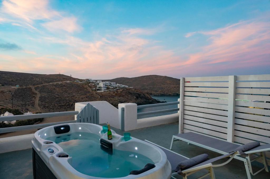 a bath tub sitting on top of a balcony at Seaview Mesonette with private Hot tub in Mikonos
