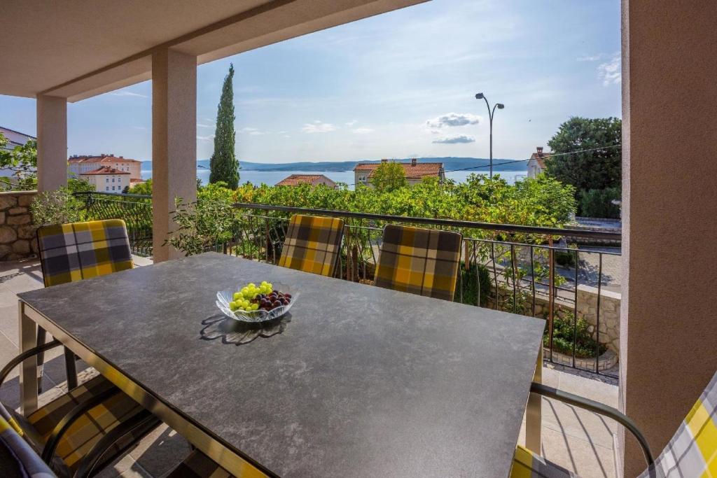 a table with chairs and a bowl of fruit on a balcony at Ferienwohnung für 7 Personen ca 100 qm in Crikvenica, Kvarner Bucht Crikvenica und Umgebung in Crikvenica