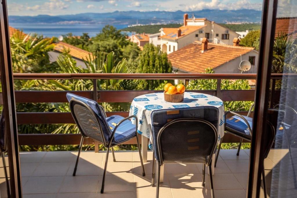 einen Tisch und Stühle auf einem Balkon mit Aussicht in der Unterkunft Ferienwohnung für 3 Personen ca 35 m in Njivice, Kvarner Bucht Krk in Njivice
