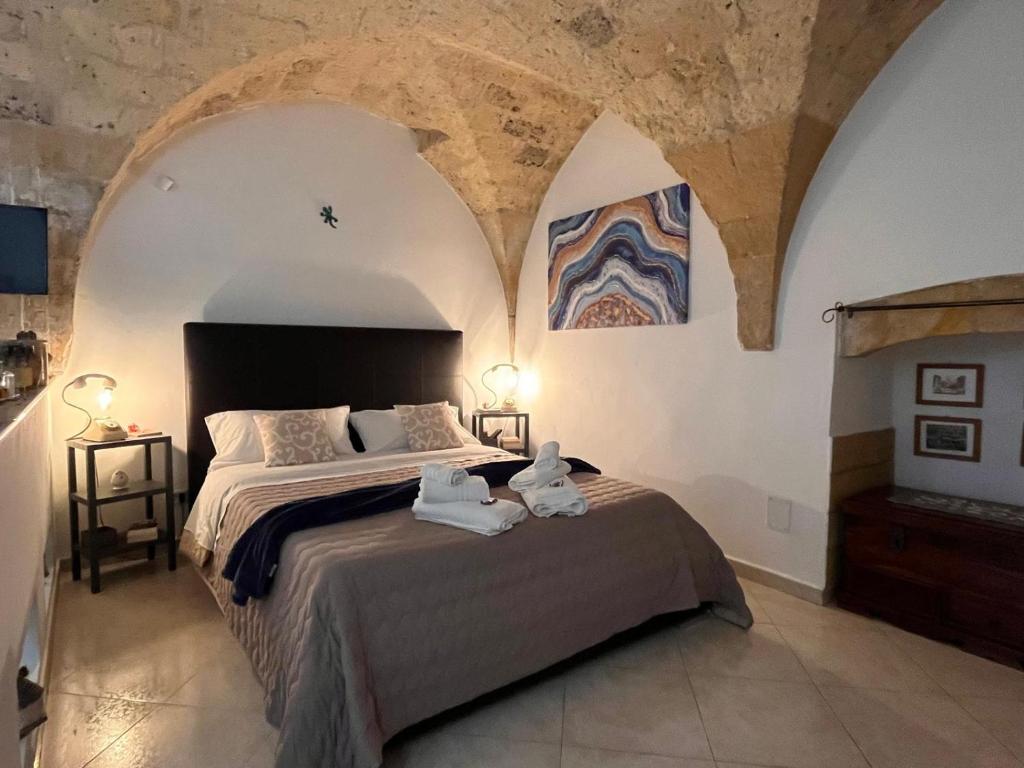 a bedroom with a bed with two towels on it at Stella del Barocco in Lecce