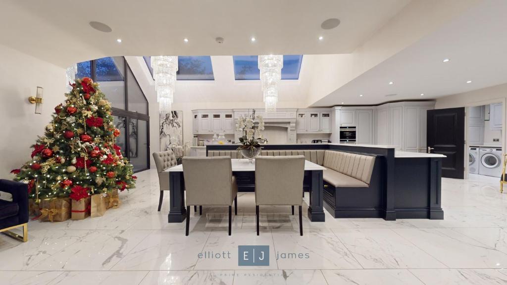 a kitchen with a christmas tree and a dining room at Grand London suburban mansion in Buckhurst Hill