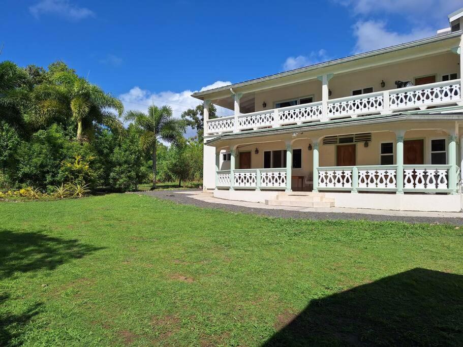 a large white house with a large yard at You 4 Ric Apartment 2: Fully-furnished 2-bedroom in Choiseul