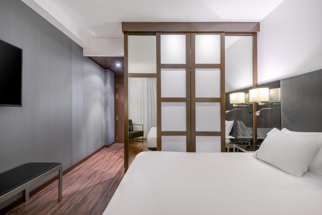 Postel nebo postele na pokoji v ubytování AC Hotel Vicenza by Marriott