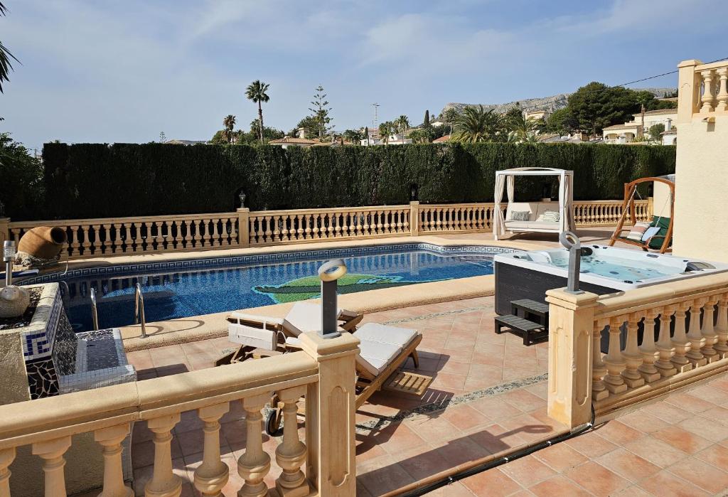 a swimming pool in a house with a fence at Luxury Villa - pool, hot tub, aircon, TVs, home cinema, office, Gbit Internet, sports equipment, car in Calpe