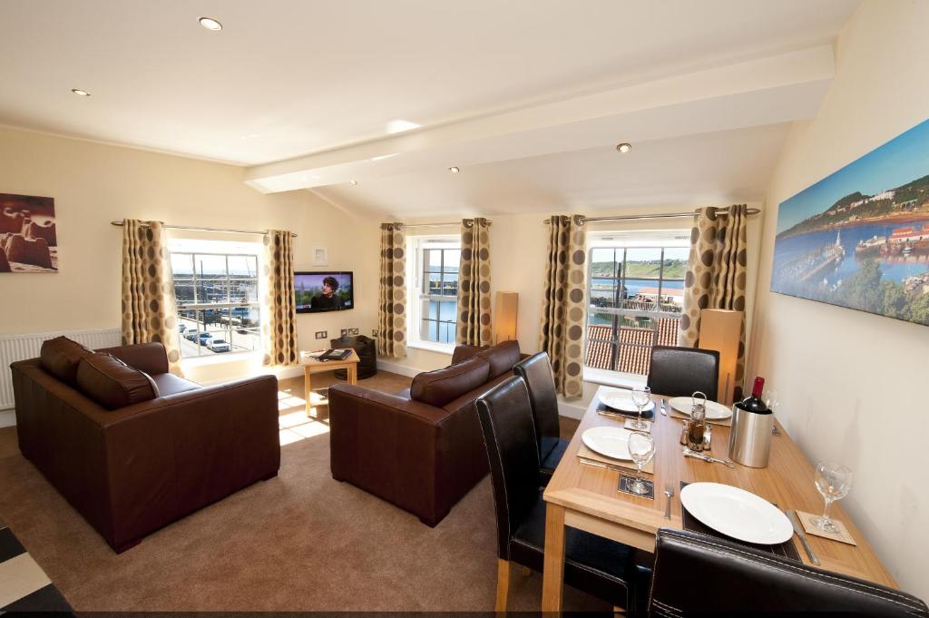 a living room with a table and chairs at Harbourside Apartments with Private Parking in Scarborough