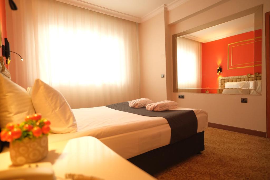 Postel nebo postele na pokoji v ubytování Malabadi Hotel