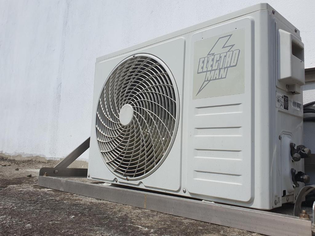 a white fan sitting on the side of a building at Sky homestay in Ampara