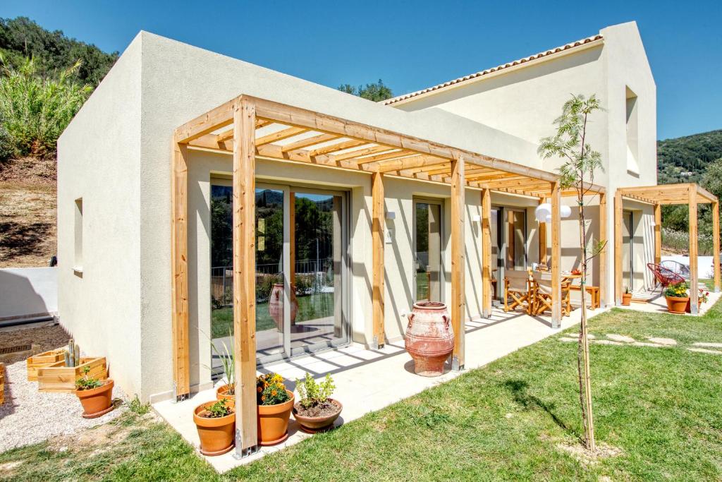 a house under construction with glass doors at Kumquart estate- Orange in Aspiotádes
