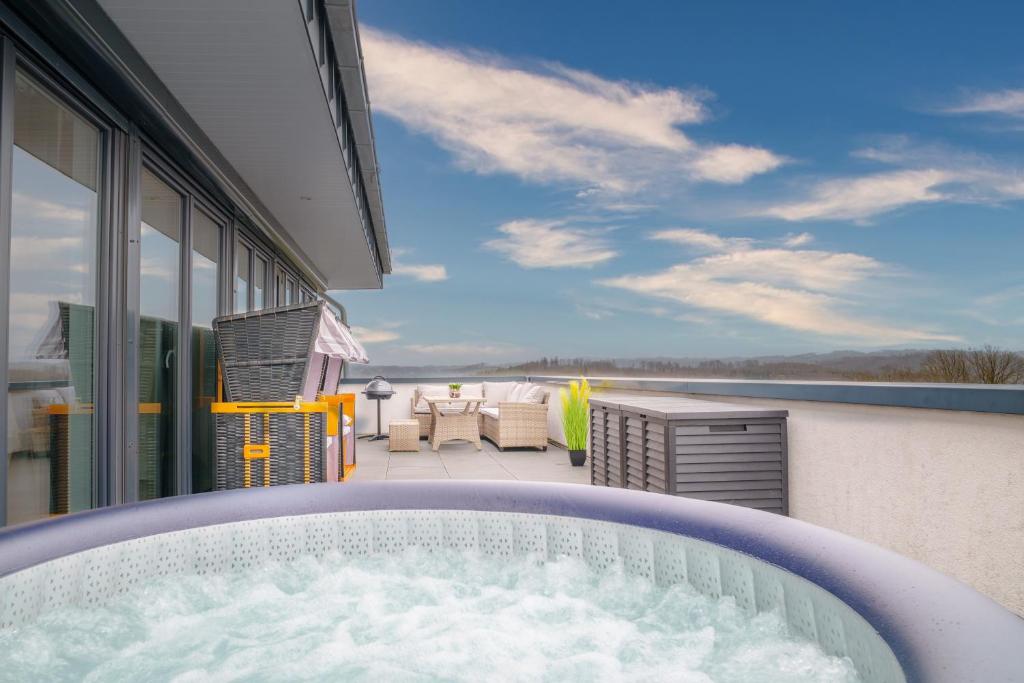 a hot tub on the balcony of a house at Immo-Vision: Penthouse Wellness in Bergneustadt