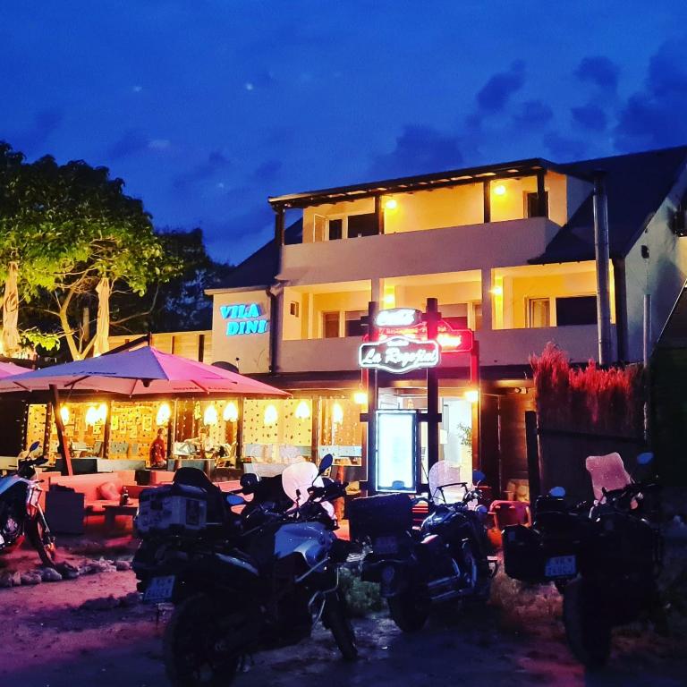 a group of motorcycles parked in front of a building at Vila Dini(La Rogojini) in Vama Veche