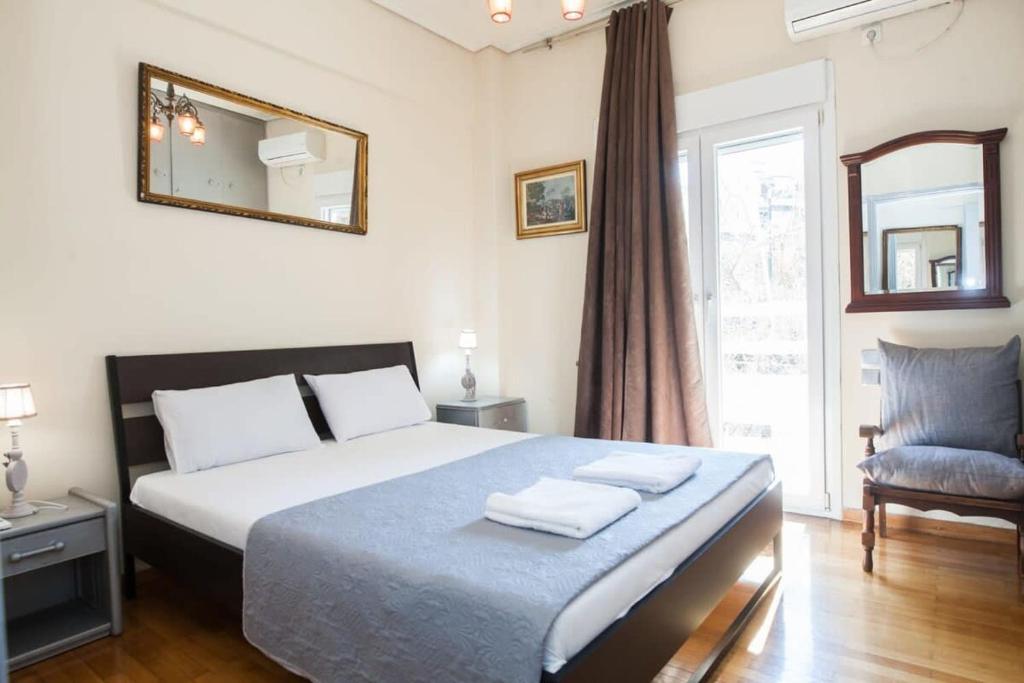 a bedroom with a bed and a mirror and a chair at Amazing apartment at Exarcheia in Athens